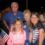 Villages Honor Flight volunteers Joe and Barbara Hambright cheer on the vets with granddaughters Hanalei and Havana.
