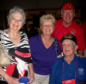 Leitha MacNeill, Darlene Bell, Marine Corps League member Bob Morrissette, from left, and Bill MacNeill, seated, share in the joy of the Villages Honor Flight homecoming on Sept. 1.
