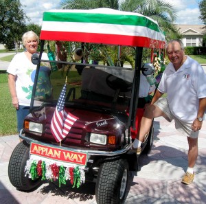 Frank Truglio and wife June show off their decorated golf cart in anticipation of Tuesday's Italian American Parade in Spanish Springs Town Square.