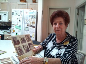 Villager Sandy Nicometo, who knew Elvis Presley and members of his family, looks through her scrapbook. 