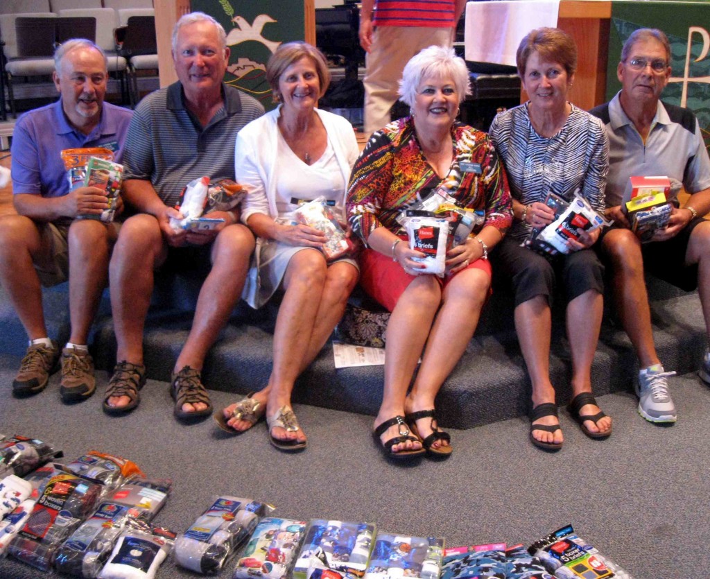Members of Hope Lutheran Church who attended Saturday's service show off some of the socks and underwear collected. 