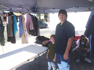 Sam Griner and his son (Sam Jr.) distribute clothes to the community