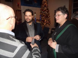 Fernando Varela signs autographs for fans while selling CDs after his Christmas show.