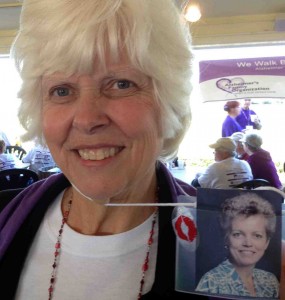 Vicki Boaz shows a photo of her sister, Tina Eizenga, on a lanyard worn in Alzheimer's Walk earlier this year.