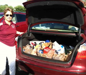 Mickey Vignona of the Chatham Chicks loads up her trunk with food collected for St. Theresa's Food Pantry.