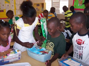 The children open their shoeboxes and find treasures inside.