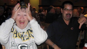 Villagers Judy Williams and Bernard Linden watch the Green Bay-Chicago game.