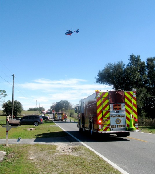 An emergency helicopter arrives on the scene of the accident on County Road 466A.