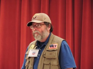 Mark Erdrich of Villages Honor Flight speaks to the group Friday.