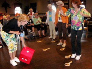 Daybreak volunteers entertain with a horse race game.