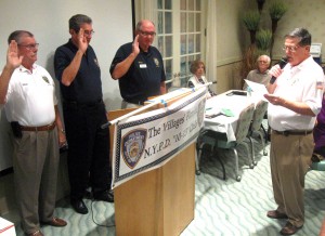 NYPD 10-13 Past President Jim Hipple, right, swears in officers.