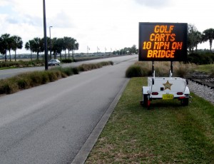 A sign at the entrance to the Lake Sumter Bridge reminds golf cart drivers of the speed limit. 