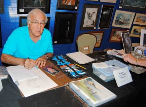 Award-winning artist and teacher, Frank Zampardi, sketched a commissioned portrait from a photograph at his exhibit table.