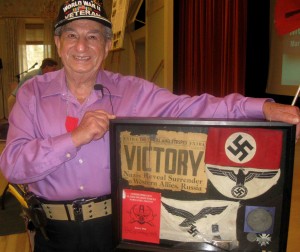 Villager Irving Locker shows off some of the Nazi memorabilia he brought back from World War II.