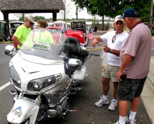Villager Joe Sorrentino, in white T-shirt, talks about his Goldwing.