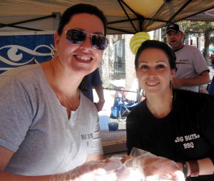 Linda Ricketson and Dawn Hughes of Lake Eye Associates are all smiles as they invite folks in to taste their barbecue at the 13th Annual BBQ Bash at Spanish Springs Town Square.