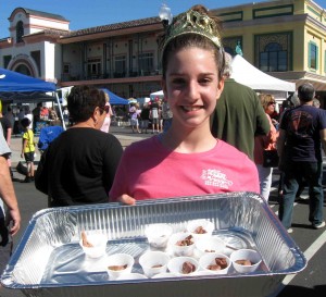 Sydney McKelvy of Anthony Torri Plumbing tempts the crowd at Spanish Springs with barbecue during the 13th Annual BBQ Bash to benefit The Villages Charter School.