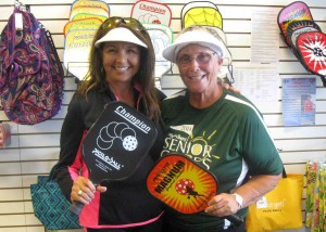 Sylvia Salazar and Gloria Miller, from left, check out the pickleball equipment at Softballs R Game.