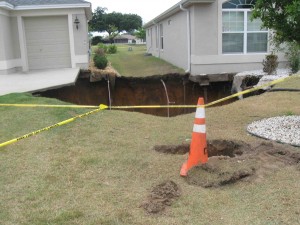 Two homes in the Village of Buttonwood are precariously perched on the edge of a sinkhole.