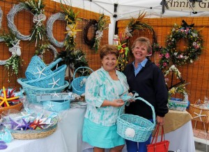 Jan Glendenin, right, purchases a large turquoise basket from Annie Gray, left.
