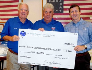 David Blackston, left, and Drew Blackston, right present a $3,000 check to Jerry Lemerise of Villages Honor Flight.