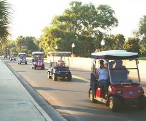 The golf cart caravan makes its way to Veterans Memorial Park.