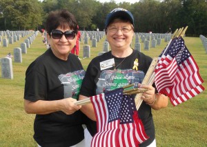 Lydia Leduc and Marguerite Desbrow are armed with flags at Florida National Cemetery.
