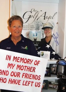 Terry Peach, a co-chair of The Lily women's golf tournament, shows a golf course sign donors can post to memorialize a loved one.