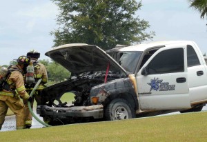 Firefighters from the Villages Public Safety Department put out a fire in the engine of a truck at noon 