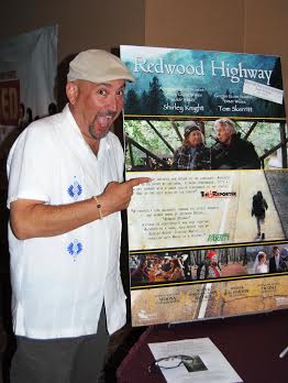 James Twyman , who wrote the movie 'Redwood Highway' with the movie poster at the Rialto theater.