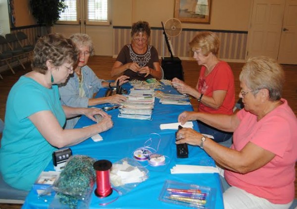 Club president, Nancy Dias, along with artists Judy Nahmias, Leda Rabenold, Laura Sandstrom and Betty Waisanen, painted, sorted and counted bookmarks for the upcoming Summer Art Festival. 