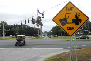 A golf cart crosses U.S. Hwy. 27/441 at 175th SE Place in Marion County.
