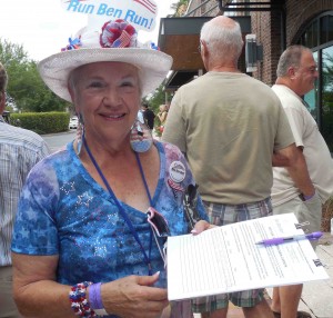 Villager Jean Brewer passes a petition for a Ben Carson presidential run. 