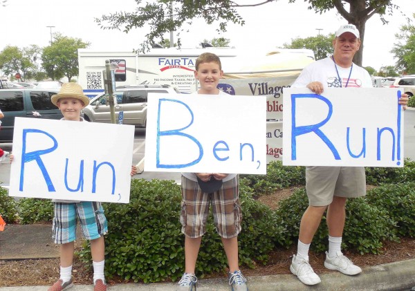 Jeremy, Jameson and Rick Falls, from left, of Citrus Springs had a message for Ben Carson.