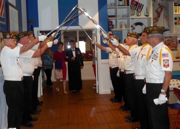 Belleview VFW Post 8083 offers a saber salute to Angie Poole as she prepares to enter with her mother. 