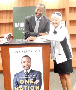 Villager Shirley Moore has her photo taken with Ben Carson.