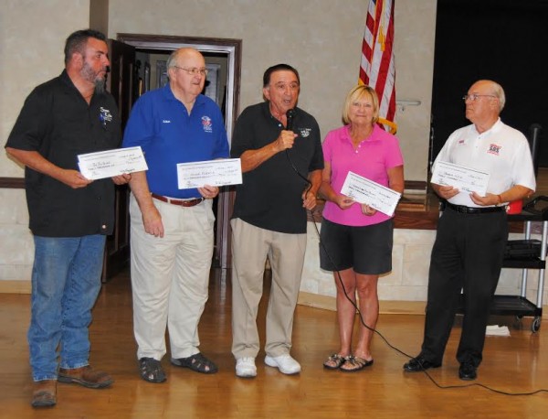 Ray Leggiero, president of the Off Broadway Players theater group (center) gave a total of $10,000 in donation checks to (l - r) David Howe (Silver Springs Sozo Kids), John Driscoll (Honor Flight); Carrol Neal (Lady Lake Christian Food Pantry) and Gary Kadow (SOS -- Save our Soldiers).