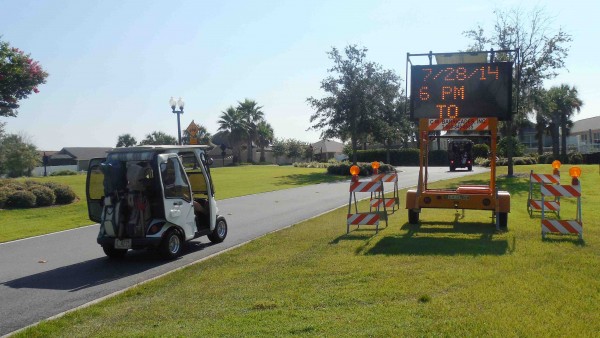 Signs are set up warning golf cart drivers about work starting next week at the tunnel at CR 466.