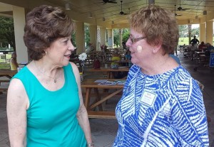Governor candidate Nan Rich, left, chats with villager Gerry Van Luven.