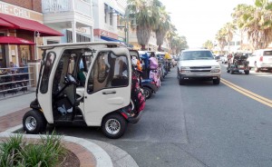 Golf carts are parked along Canal Street in Lake Sumter Landing.