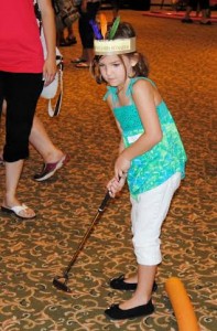 A young golfer takes her best shot.