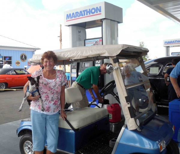 Dorothy and Don Kibler with their dog Dallas. Don was busy filling up their golf cart's gas tank. 