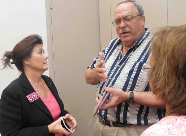 Ed Nichols of Eustis chats with Denise Dymond Lyn, a judicial candidate.