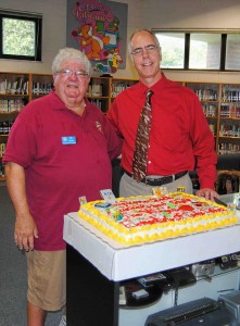 Rotarian Ira Pozen and school principal, Dave Bordenkircher, eye the big cake! 