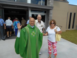 Father Pedro (Peter) Punal greets parishioners Saturday afternoon.