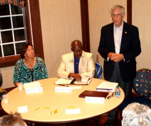 Donna Kempa, left, listens as Russ D'Emidio speaks. VHA member Walter Martin, center, moderates.