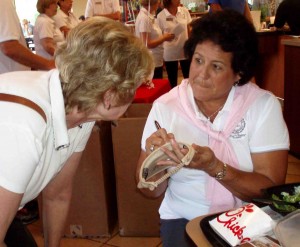 Nancy Lopez signs a visor for Gay Hensley of the Village of Hillsborough