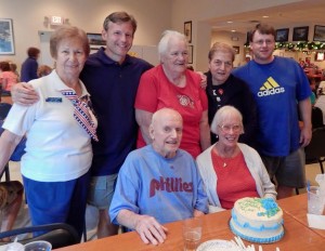 Villager Leo Mullen, in Phillies shirt, celebrates his birthday and with American Legion Auxiliary members.