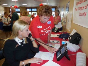 Pam Bondi makes a call to a voter with the assistance of Barbara Qualls during a visit to The Villages GOP headquarters on Oct. 13.