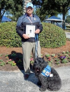 Howard Horwitz received an award for more than 700 service dog visits with 'Dice' to healthcare facility patients.